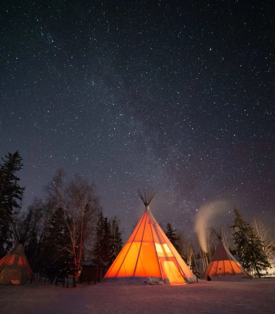 Aurora village yellowknife northwest territories canada aurora borealis northern lights winter orange credit chris milkyway teepee image