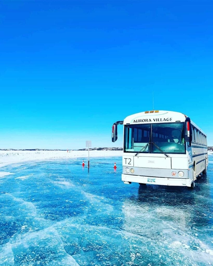 Aurora village yellowknife northwest territories canada portrait aurora borealis northern ice road bus
